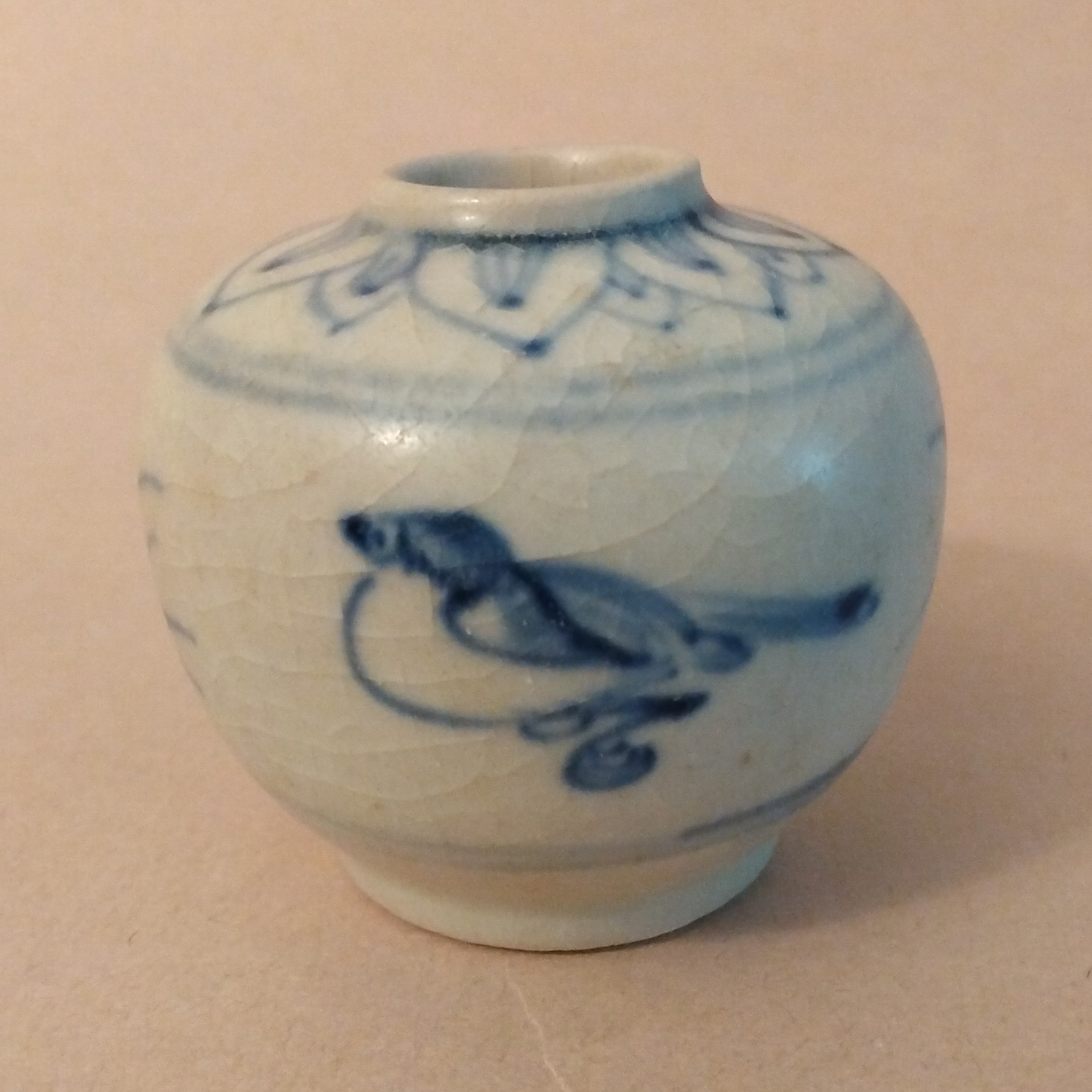 Ceramic Jarlet with underglaze cobalt blue decoration of birds and grasses on the body and lotus petals around the shoulders. Vietnam, ca. 15-17th C